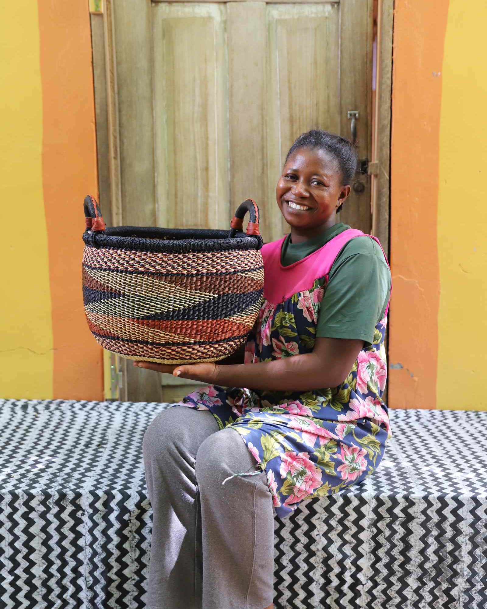 Handwoven Gbenka storage basket, medium, displayed in a home interior setting