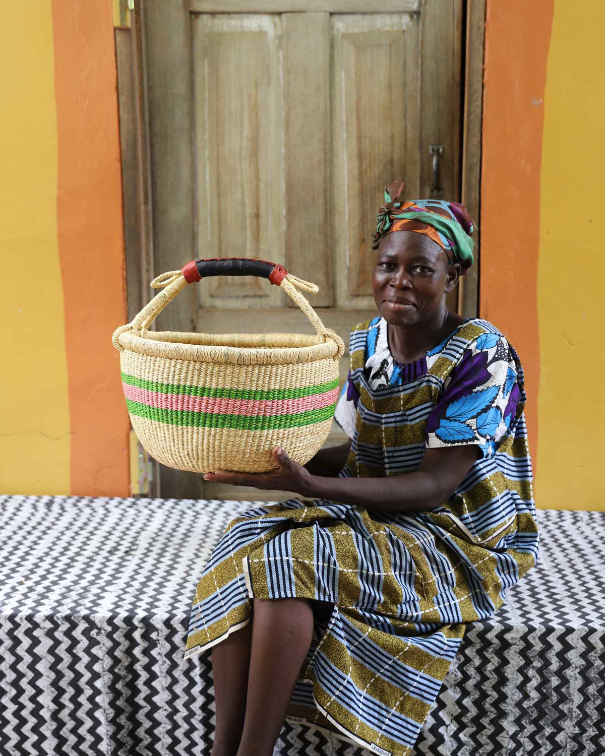 Medium handwoven African basket in elephant grass, 38 cm wide with twin handles.