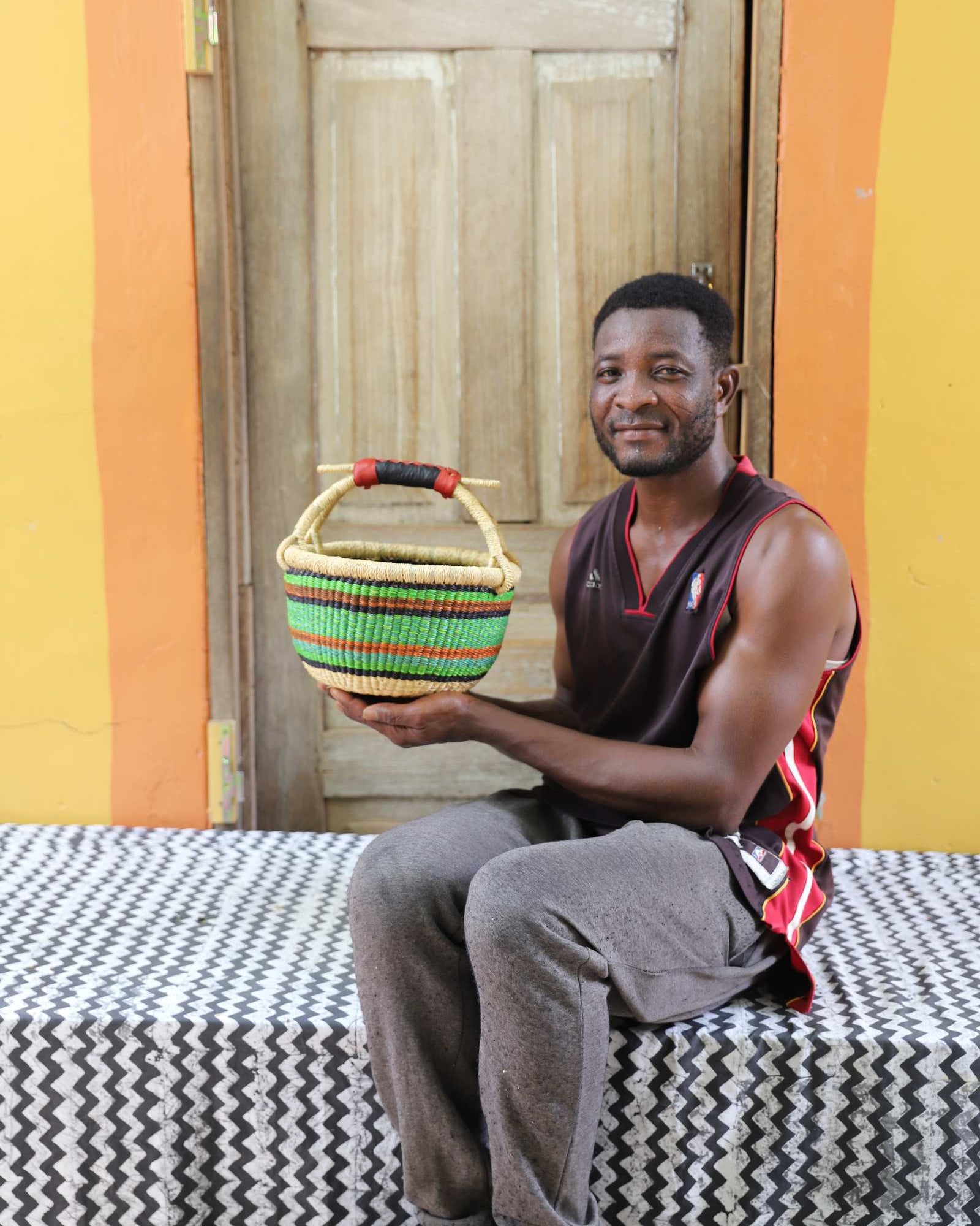 Small handwoven African basket in elephant grass, 30 cm wide and 17 cm tall.
