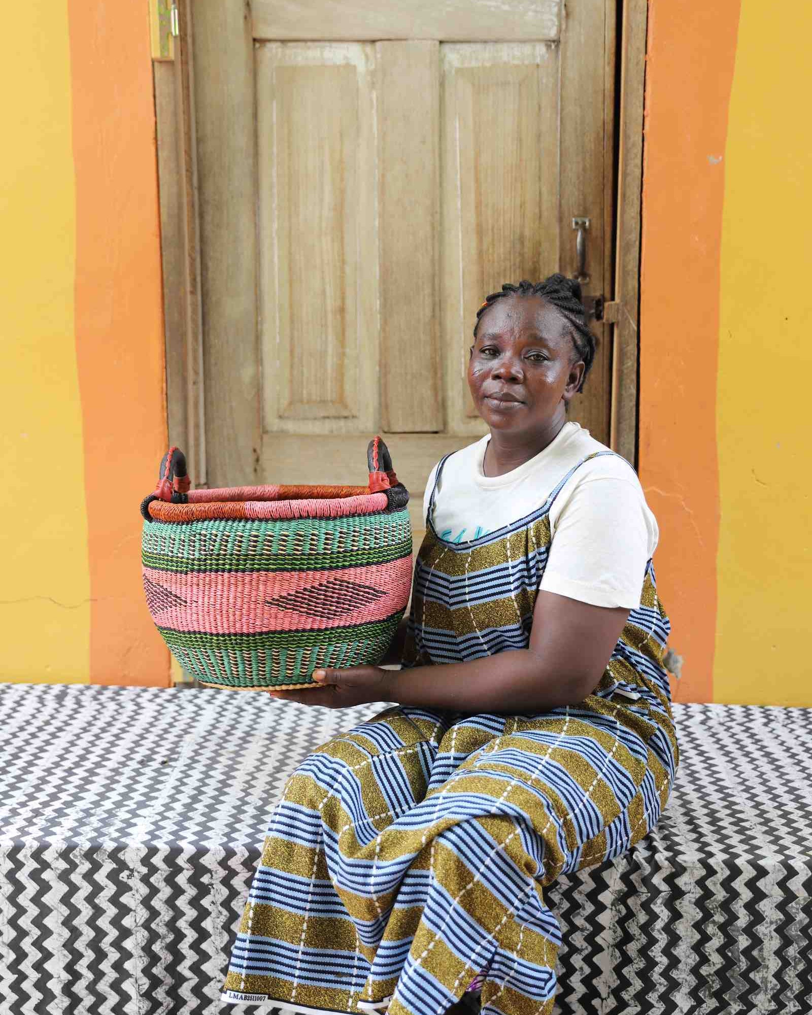 Handwoven Bolga basket in elephant grass, a sieve-derived form standing 28 cm tall.