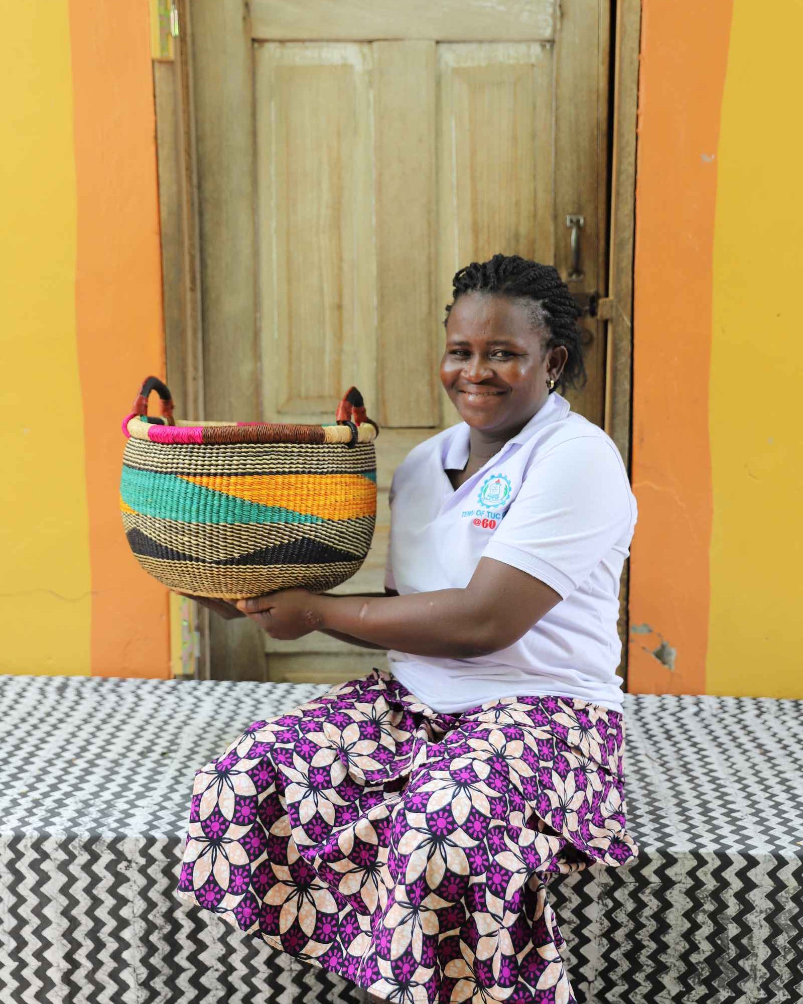 Open handwoven Bolga basket in elephant grass, for fruit, textiles, or keepsakes.