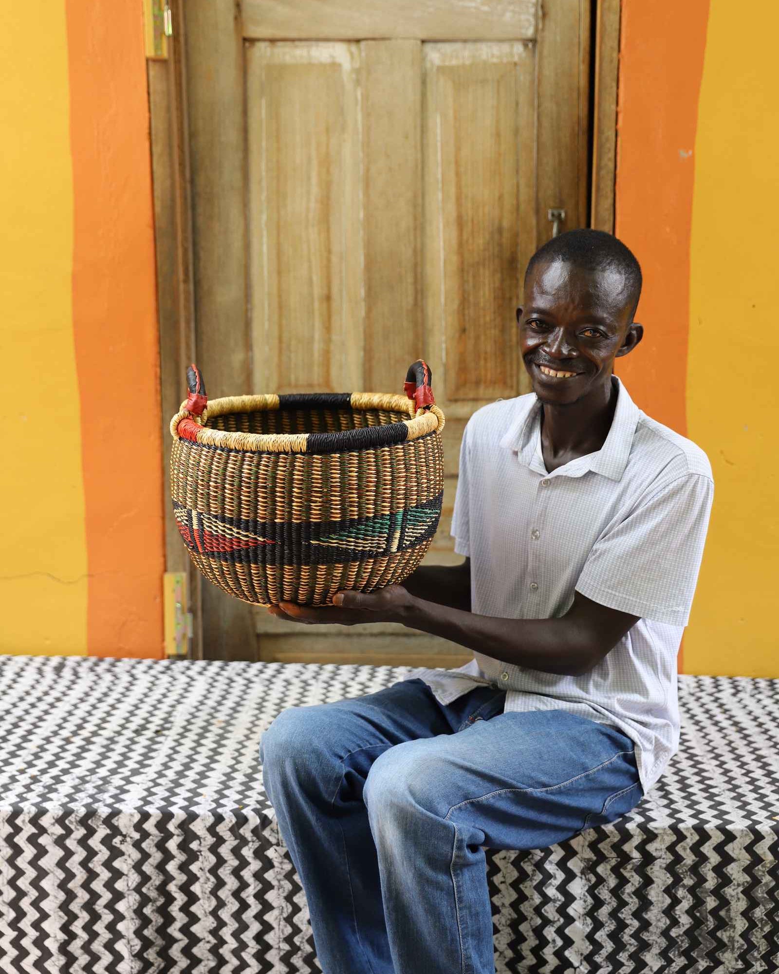 Handwoven African basket in elephant grass, an open storage form 23 cm tall.