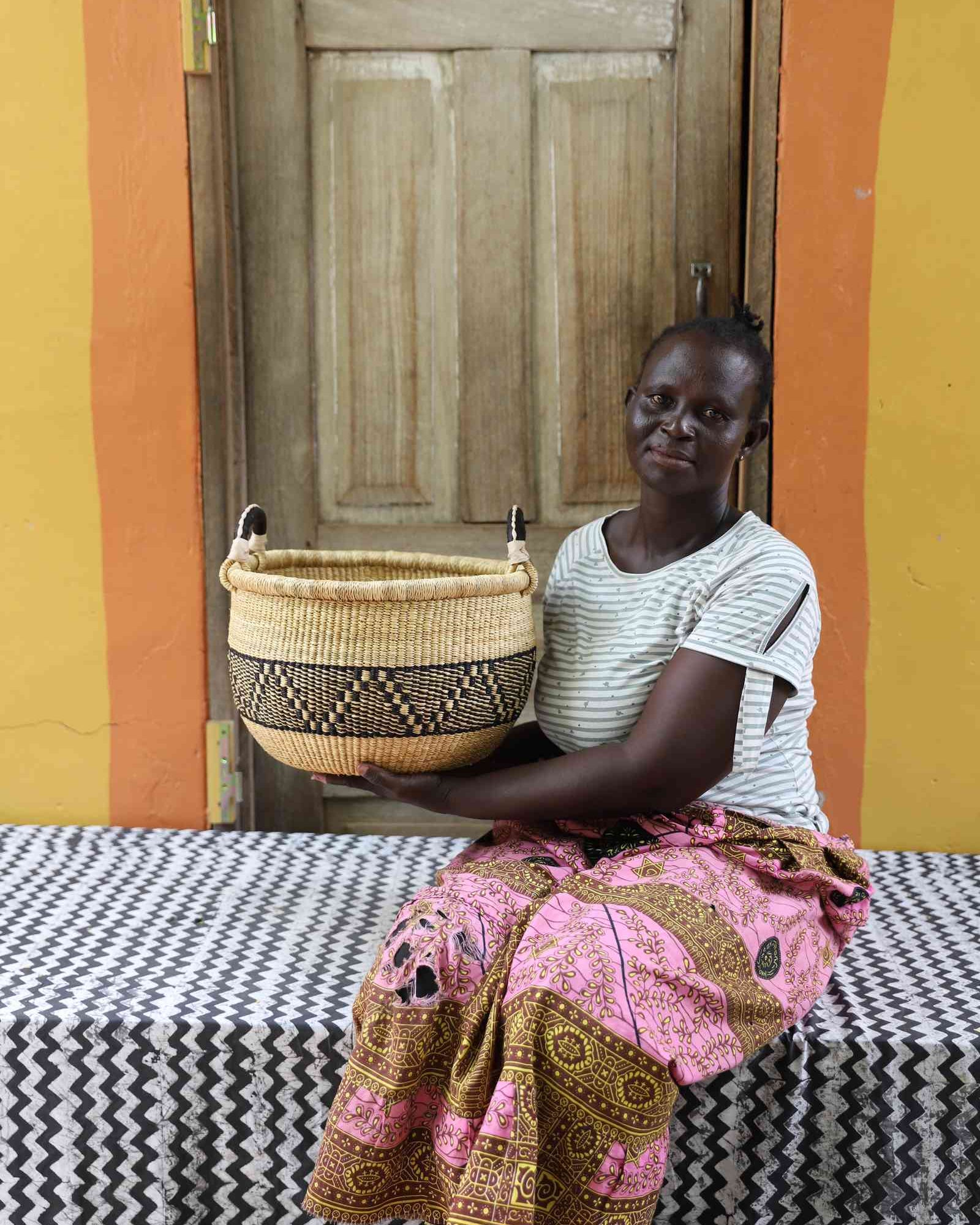 Handwoven African basket in elephant grass, a shallow open form for fruit or textiles.