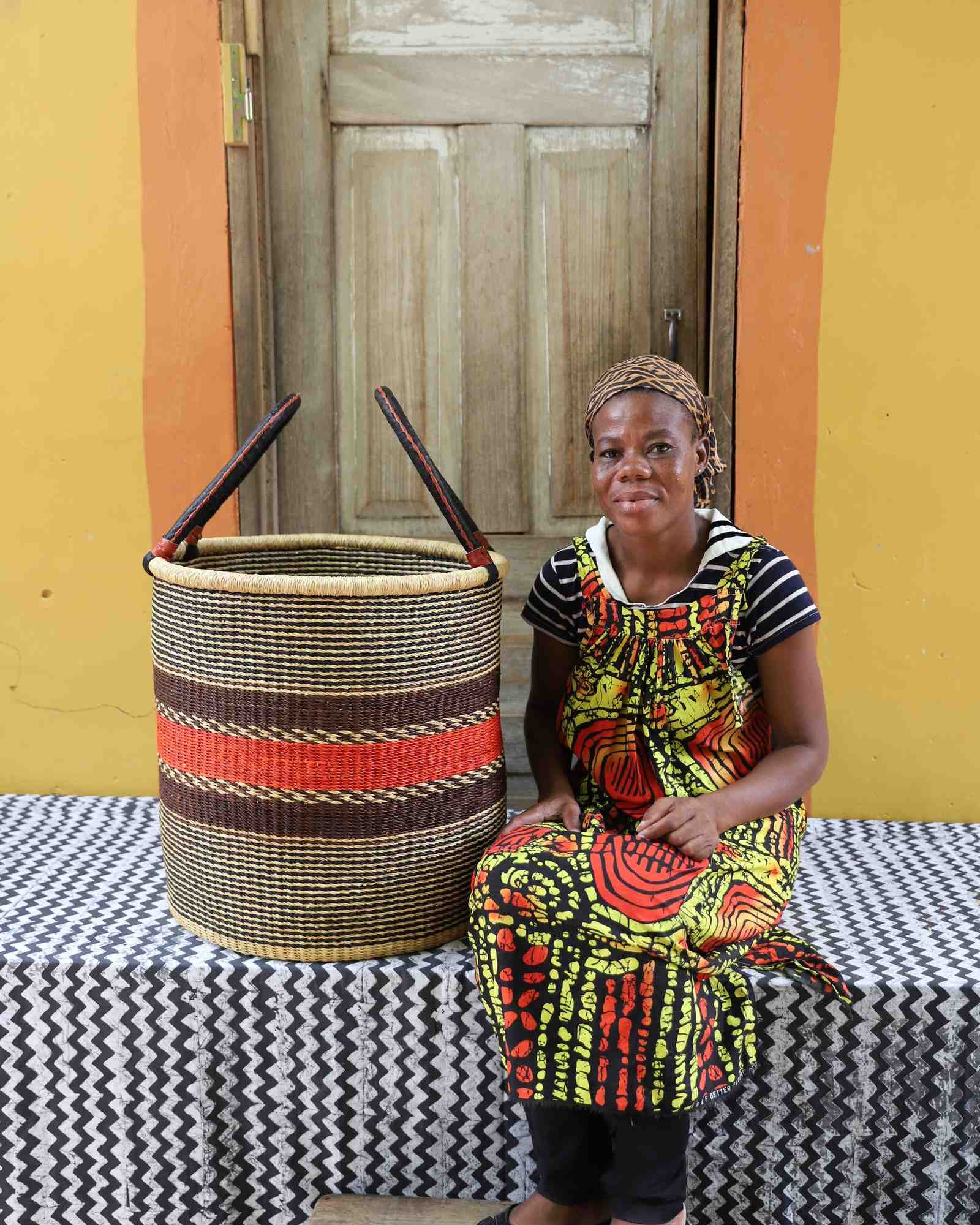 Handwoven Bolga laundry basket in elephant grass, scaled for a living room or nursery.