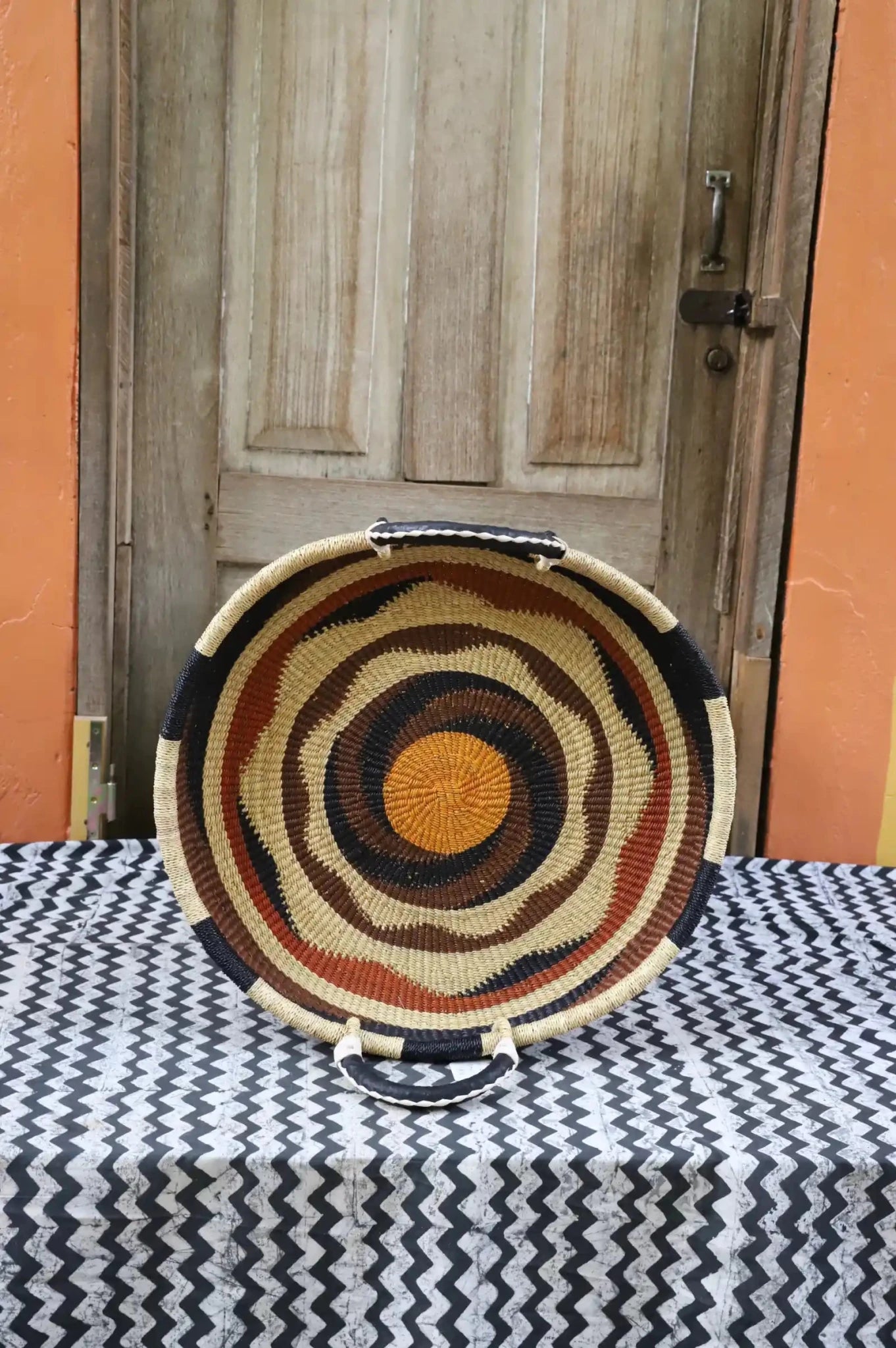 Premium elephant grass tray with leather handles. Bolgatanga artisan craftsmanship.