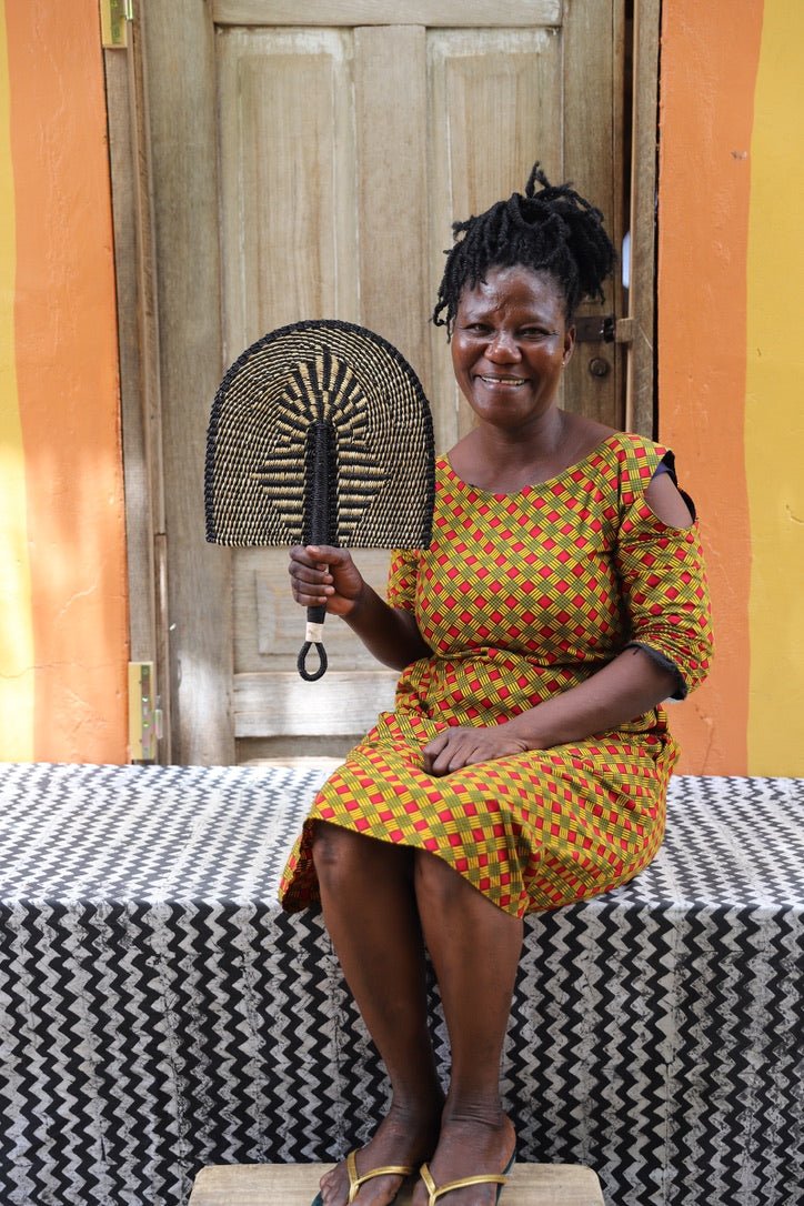 The Baba Tree Bolga Original Fan: Handwoven architectural wall art with intricate weave and premium leather handle.