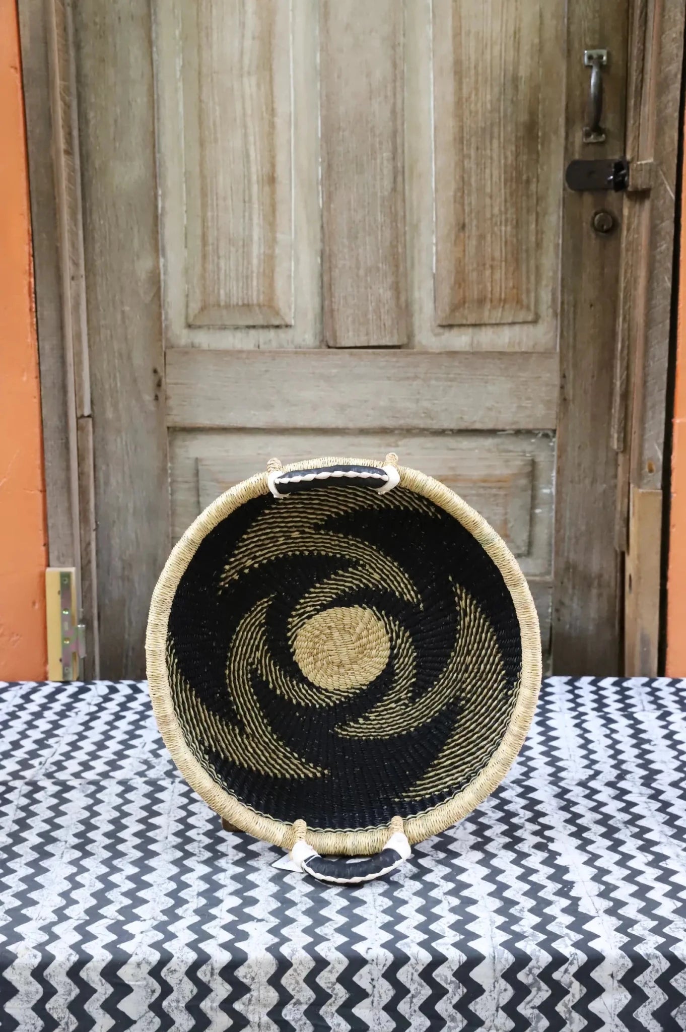 Premium elephant grass tray with leather handles. Bolgatanga artisan craftsmanship.