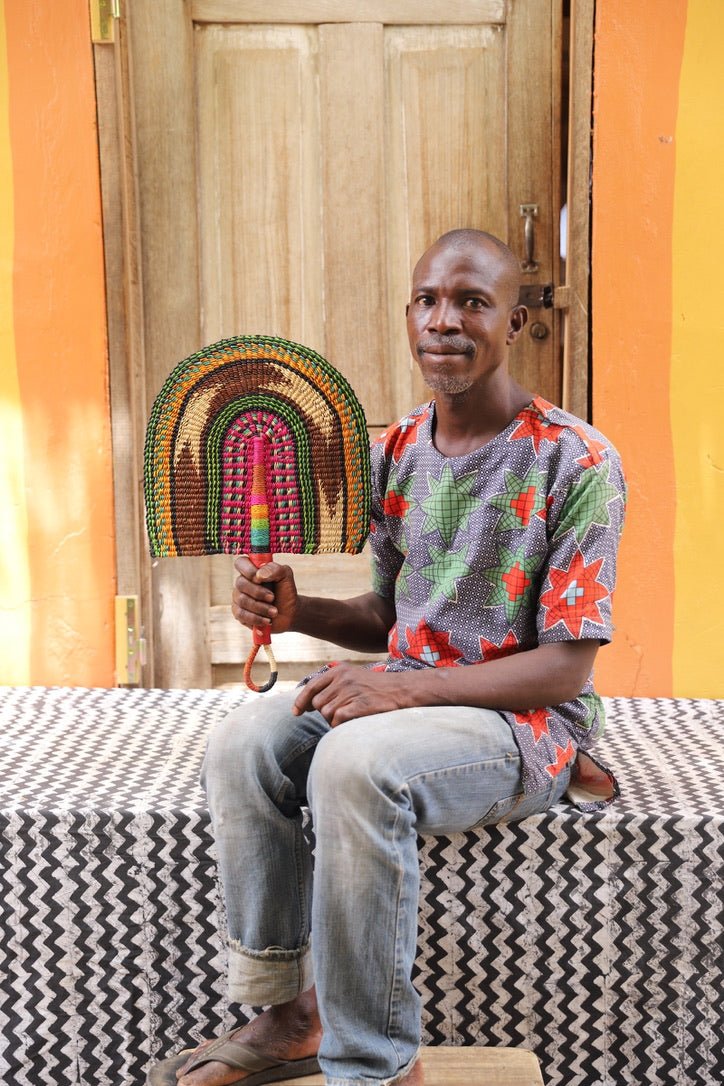 The Baba Tree Bolga Original Fan: Handwoven architectural wall art with intricate weave and premium leather handle.
