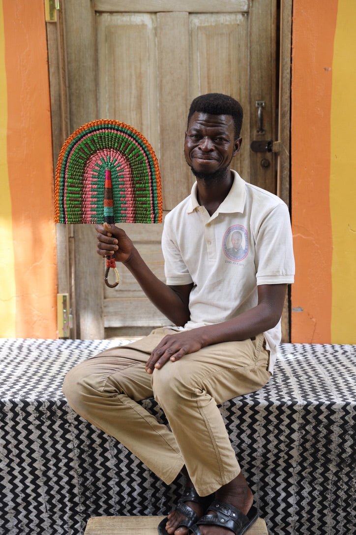 The Baba Tree Bolga Original Fan: Handwoven architectural wall art with intricate weave and premium leather handle.