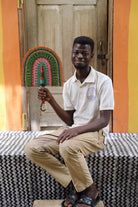 The Baba Tree Bolga Original Fan: Handwoven architectural wall art with intricate weave and premium leather handle.