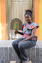 The Baba Tree Bolga Original Fan: Handwoven architectural wall art with intricate weave and premium leather handle.