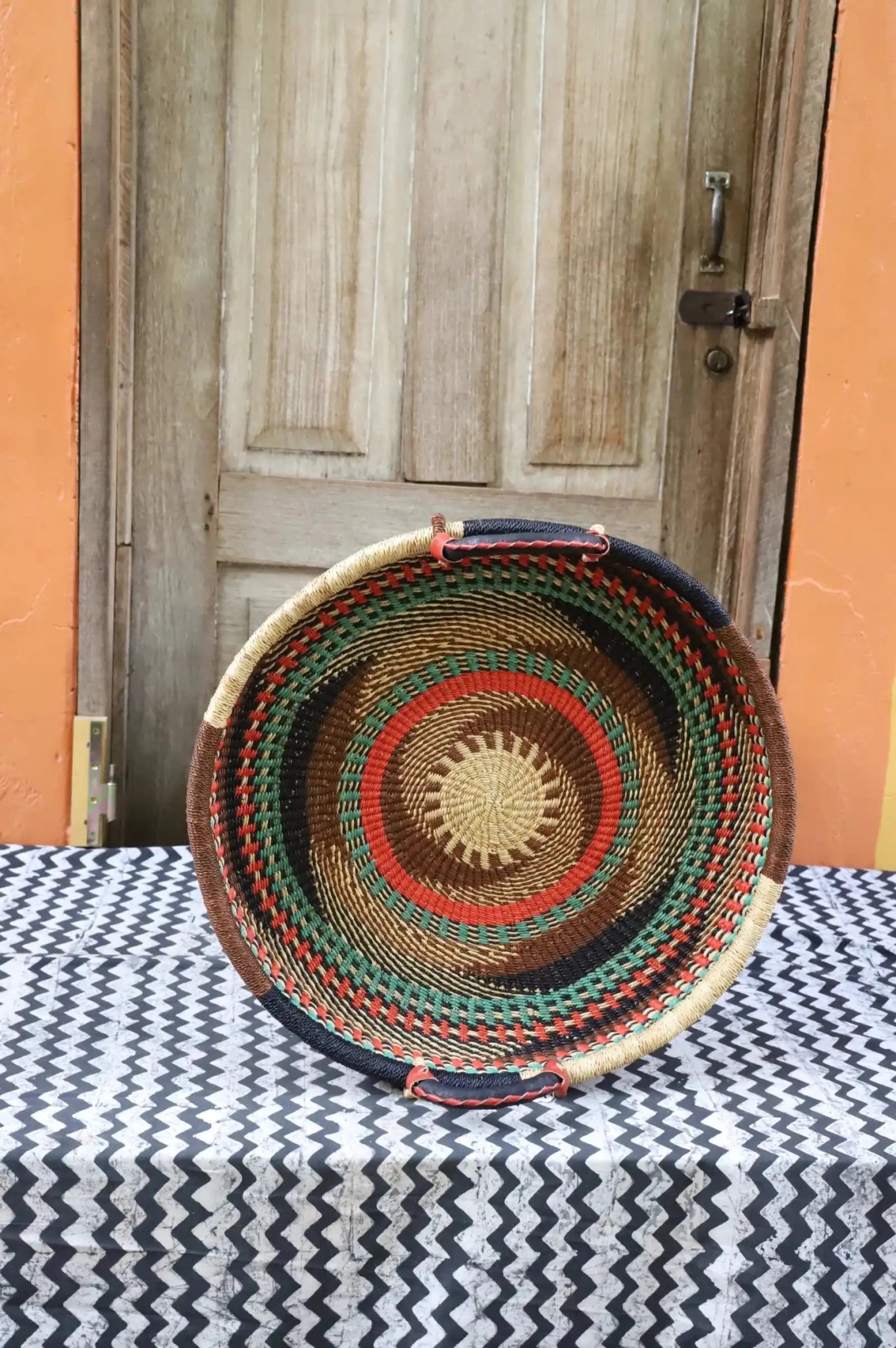 Premium elephant grass tray with leather handles. Bolgatanga artisan craftsmanship.