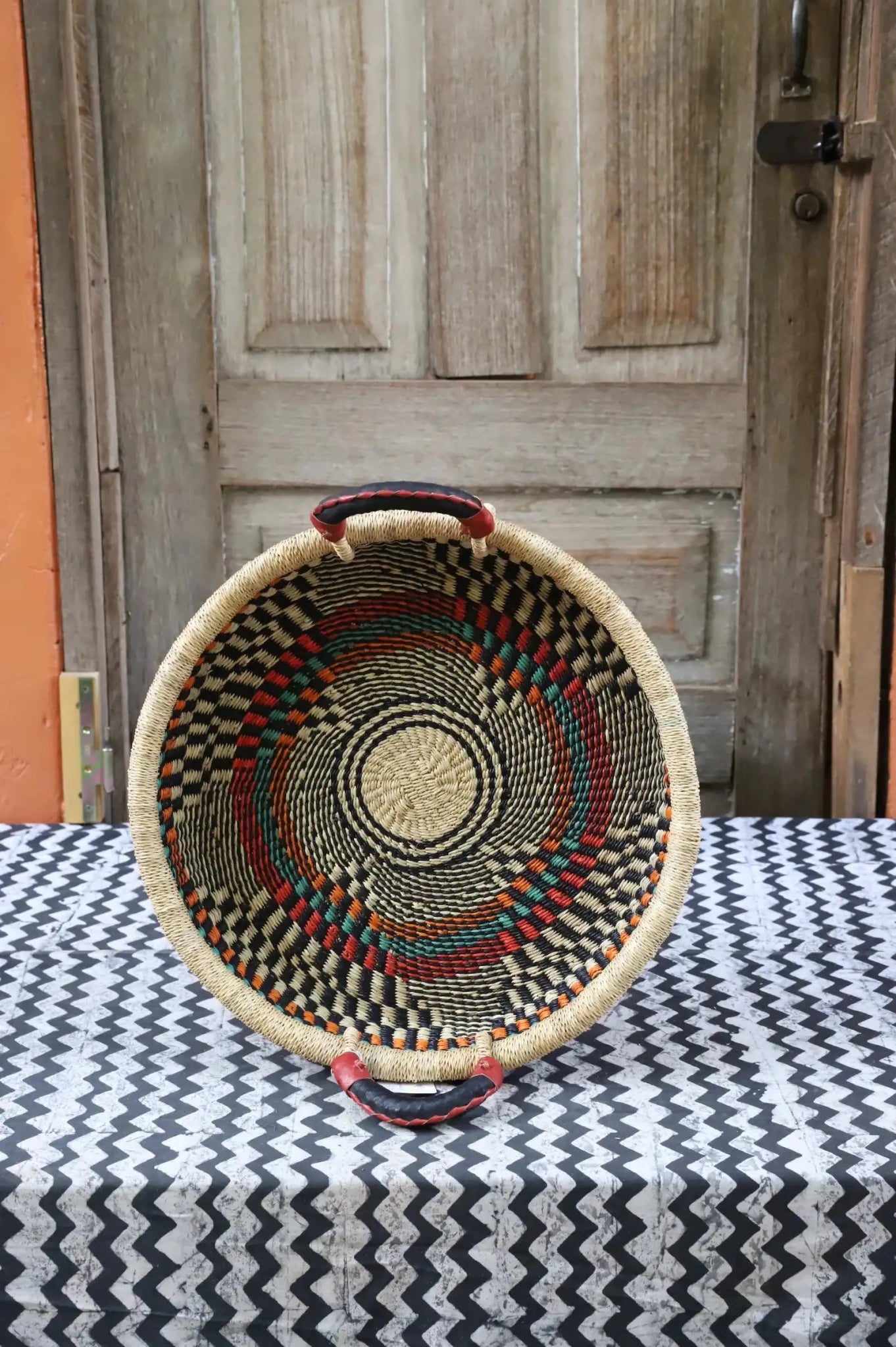 Premium elephant grass tray with leather handles. Bolgatanga artisan craftsmanship.