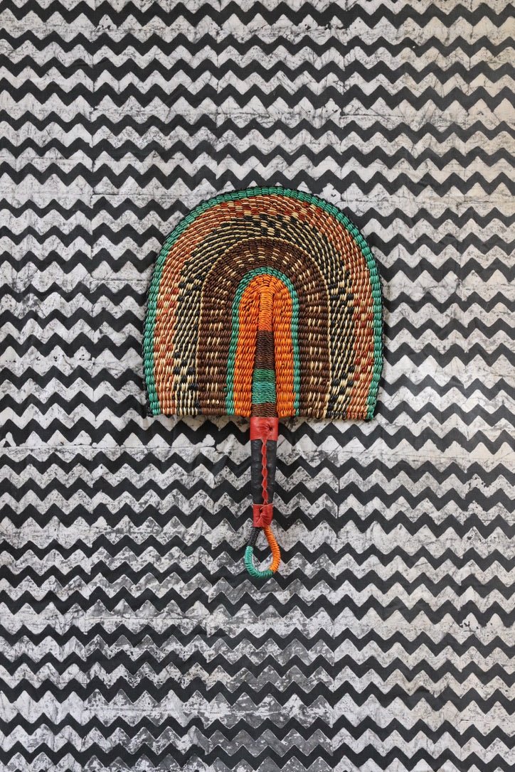 The Baba Tree Bolga Original Fan: Handwoven architectural wall art with intricate weave and premium leather handle.
