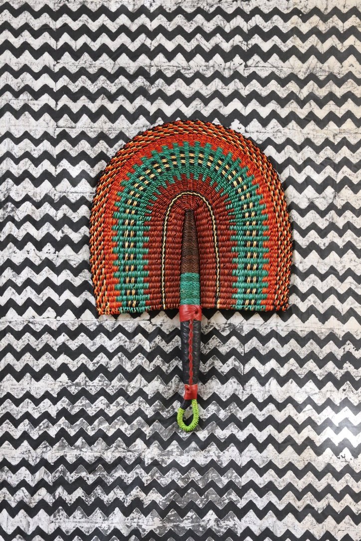 The Baba Tree Bolga Original Fan: Handwoven architectural wall art with intricate weave and premium leather handle.