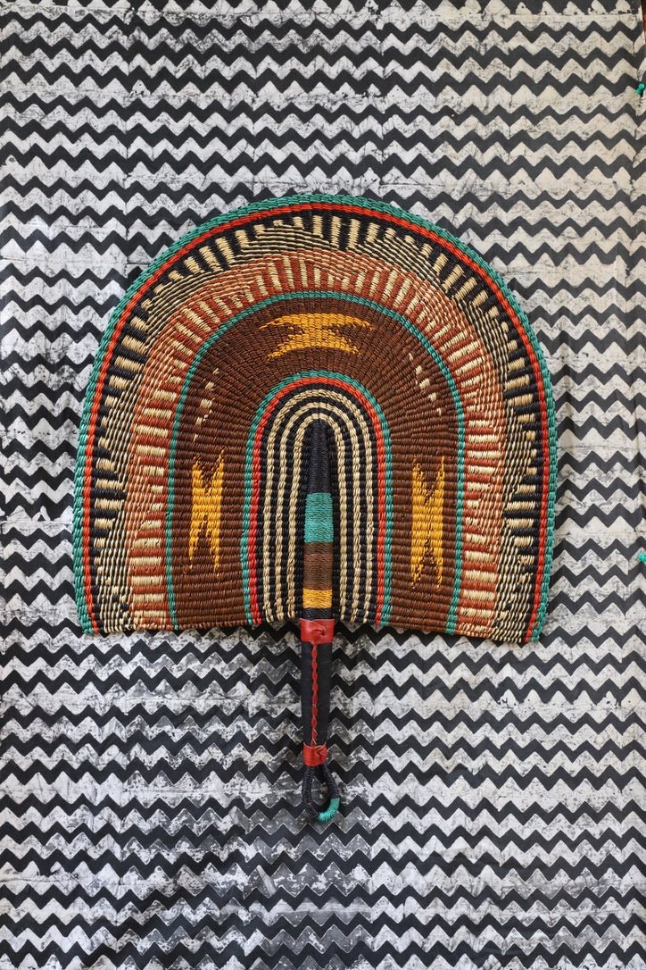 Naba Pengo Fan by The Baba Tree. Premium handwoven elephant grass wall art and artisanal Bolgatanga home decor.