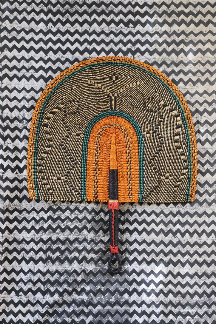 Naba Pengo Fan by The Baba Tree. Premium handwoven elephant grass wall art and artisanal Bolgatanga home decor.