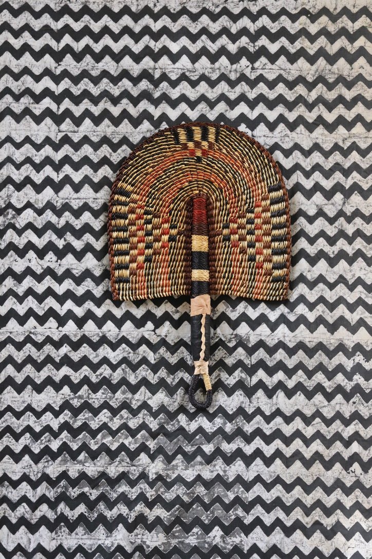 The Baba Tree Bolga Original Fan: Handwoven architectural wall art with intricate weave and premium leather handle.