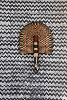 The Baba Tree Bolga Original Fan: Handwoven architectural wall art with intricate weave and premium leather handle.