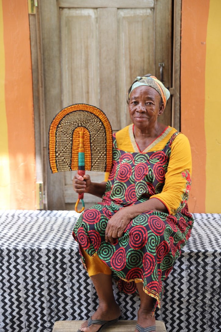 The Baba Tree Bolga Original Fan: Handwoven architectural wall art with intricate weave and premium leather handle.