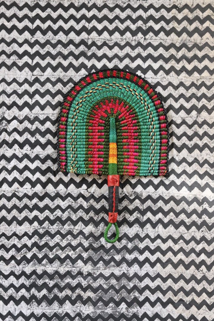 The Baba Tree Bolga Original Fan: Handwoven architectural wall art with intricate weave and premium leather handle.