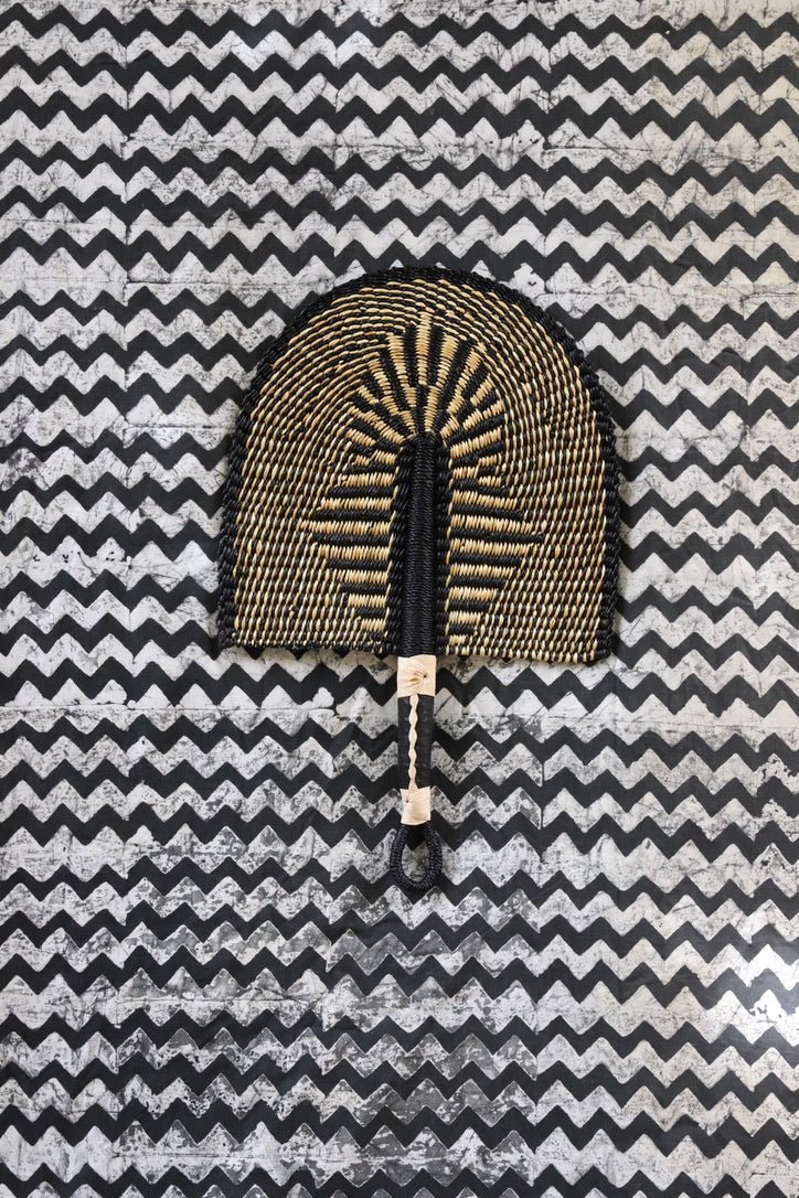 The Baba Tree Bolga Original Fan: Handwoven architectural wall art with intricate weave and premium leather handle.