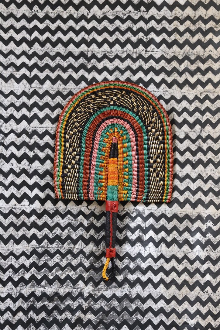 The Baba Tree Bolga Original Fan: Handwoven architectural wall art with intricate weave and premium leather handle.