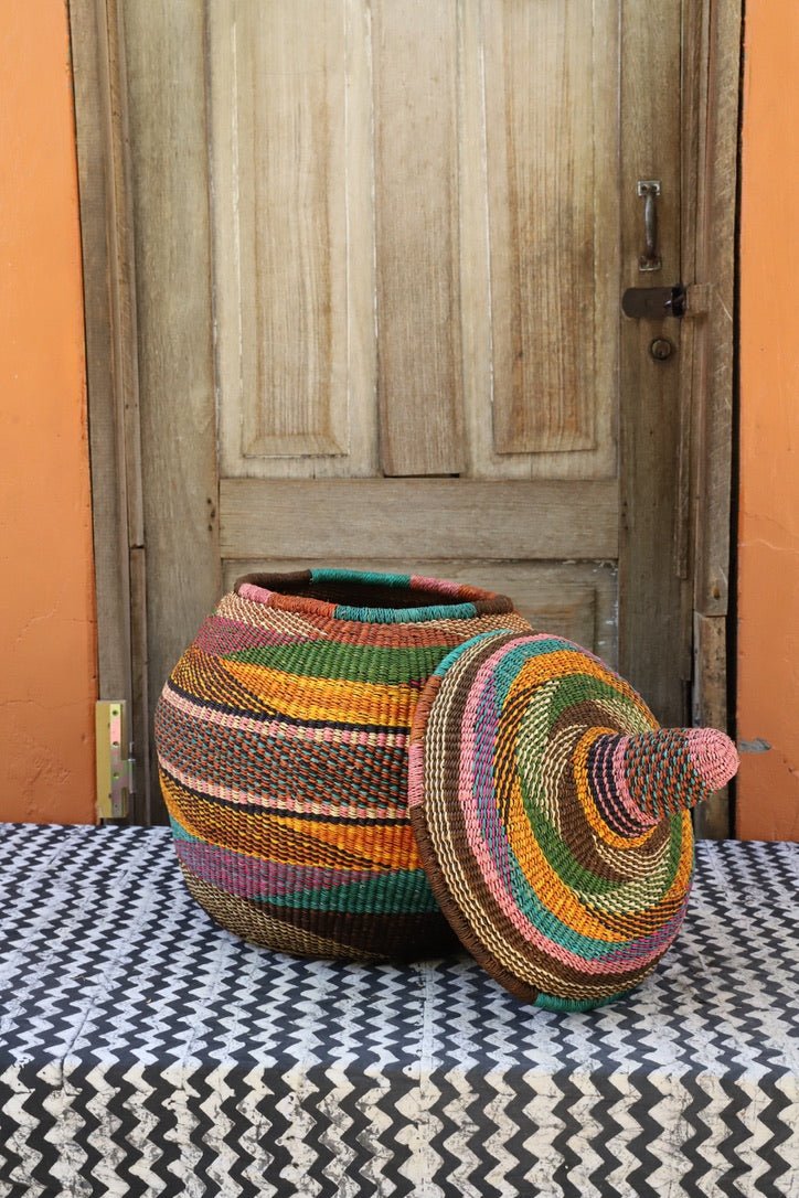 Large Orbit storage basket in multicolour stripes, lid off and tilted to the side
