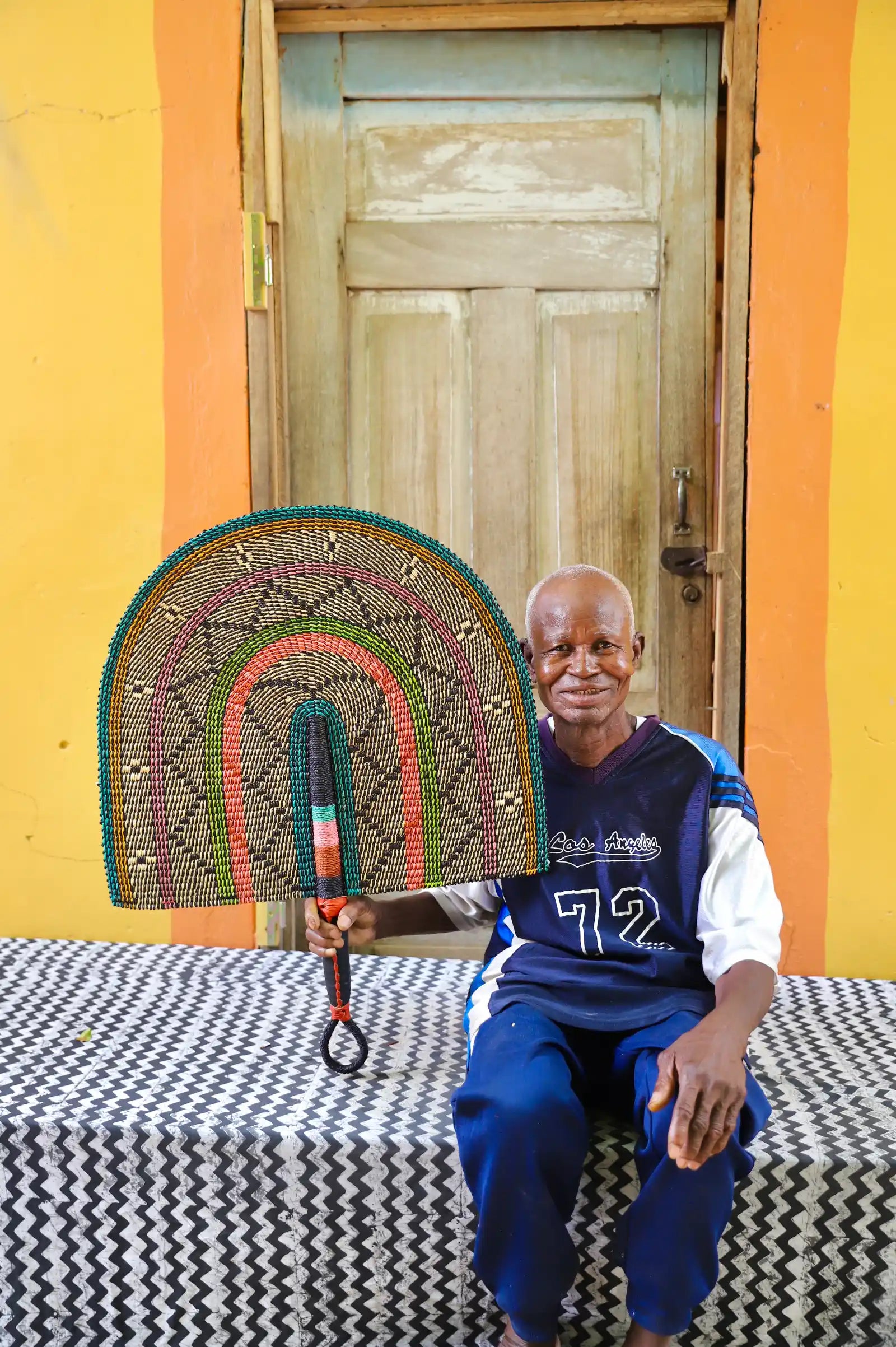 The Baba Tree Bolga Original Fan: Handwoven architectural wall art with intricate weave and premium leather handle.