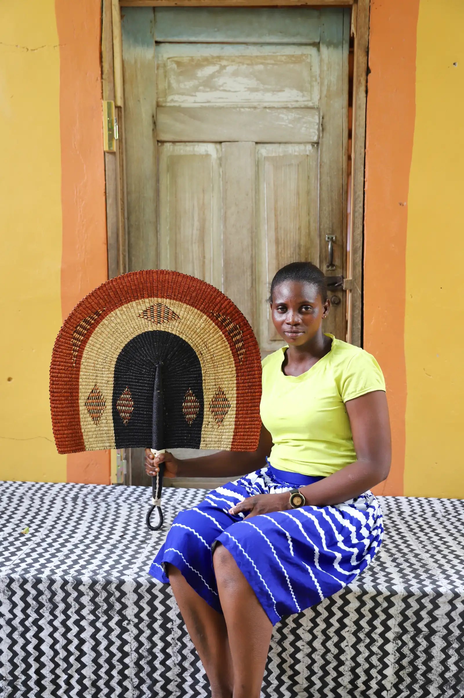The Baba Tree Bolga Original Fan: Handwoven architectural wall art with intricate weave and premium leather handle.