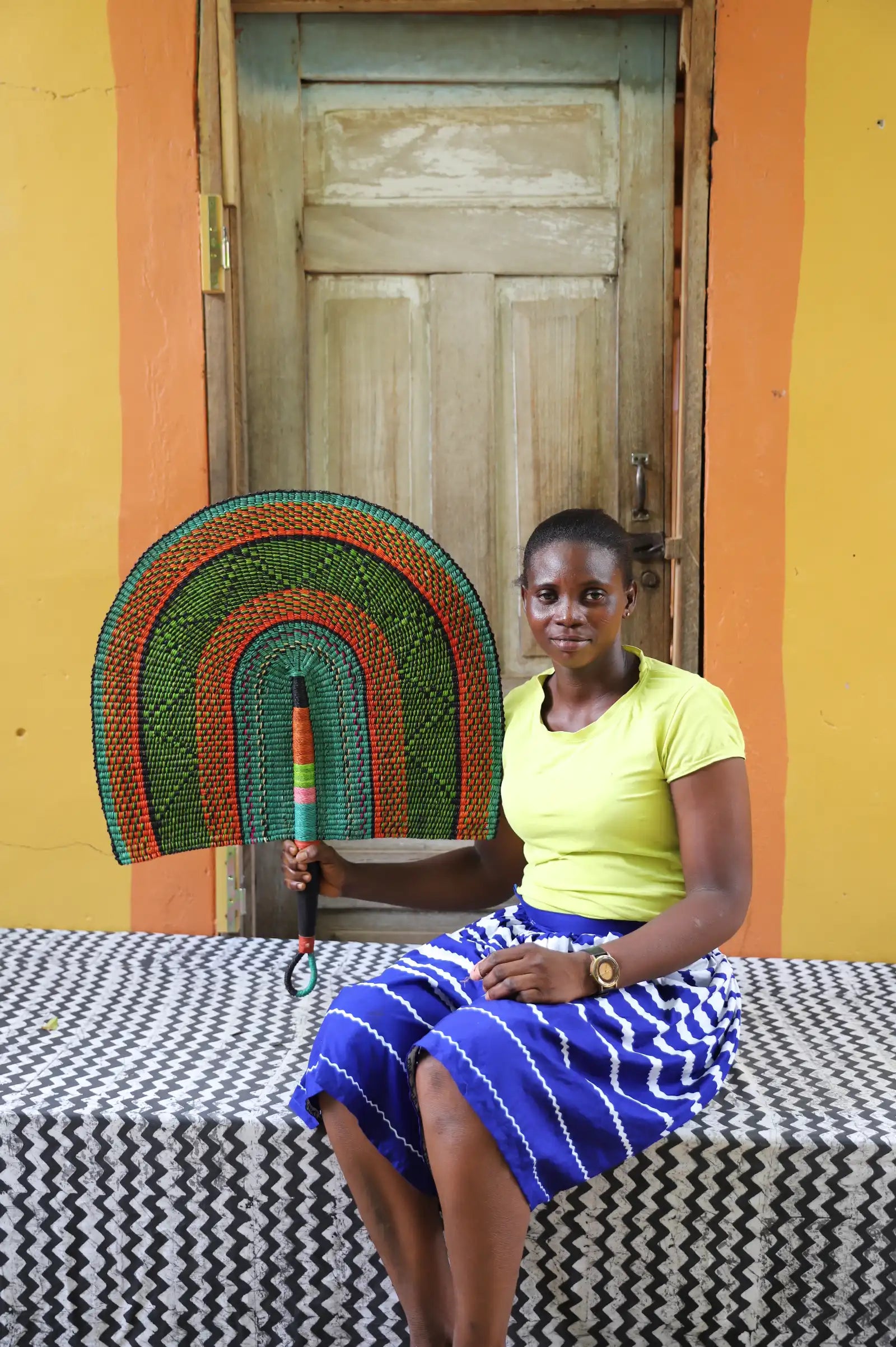 The Baba Tree Bolga Original Fan: Handwoven architectural wall art with intricate weave and premium leather handle.