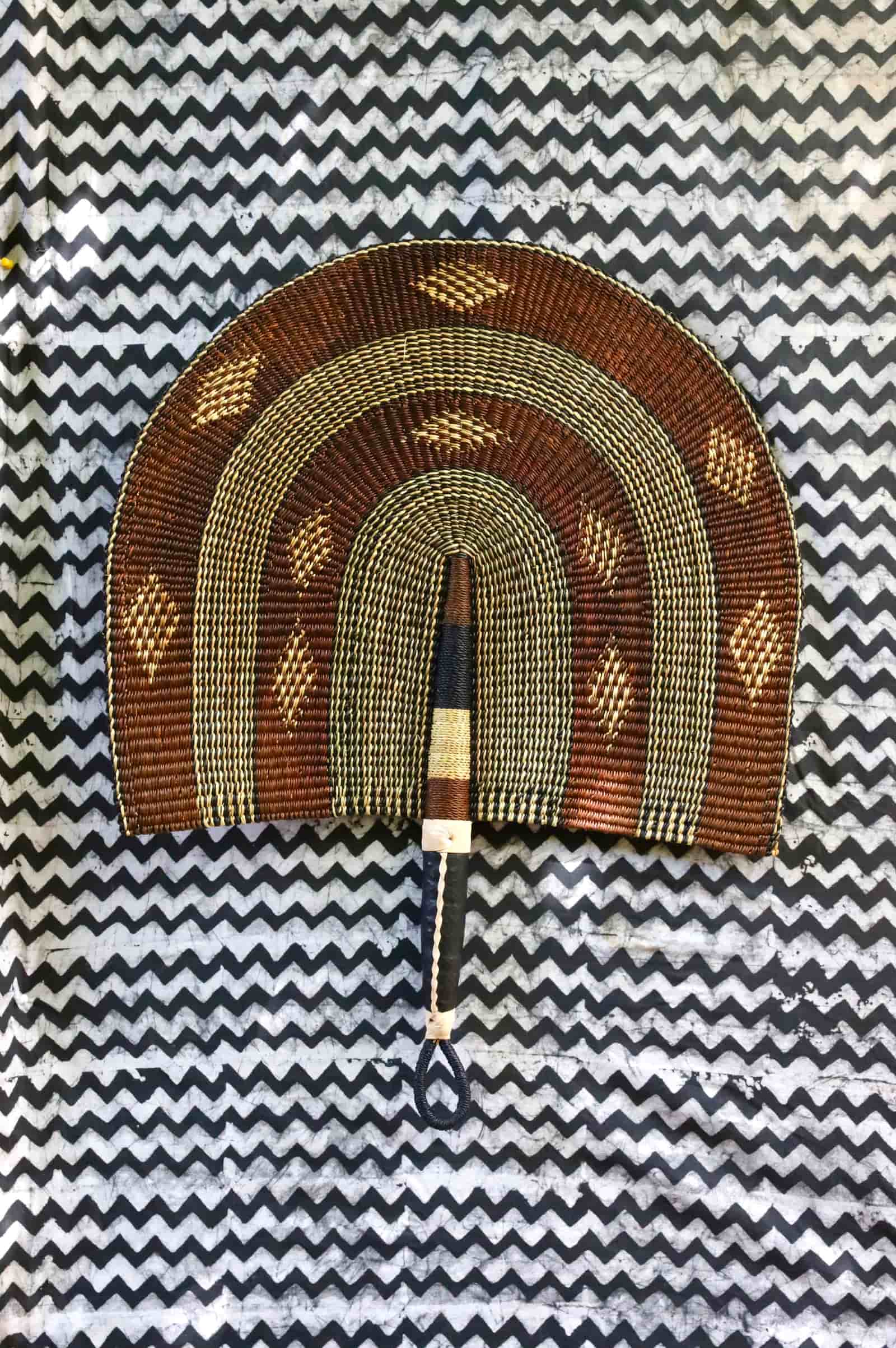 Naba Penga wall décor: brown and cream rainbow arch with diamond motifs, flat lay