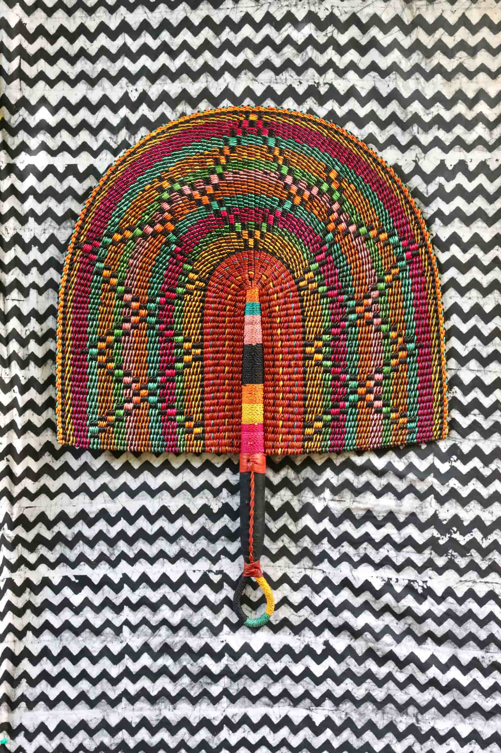 Naba Penga wall décor: burgundy rainbow arch with multicolour spot pattern, flat lay