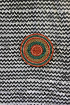 Small woven placemat with terracotta centre, teal ring and gold outer band
