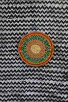 Small woven placemat set of 4 — green and orange concentric rings on natural straw
