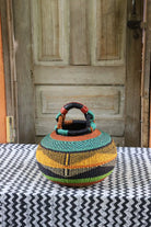 Small pot storage basket with teal dome and black, yellow and lime green body