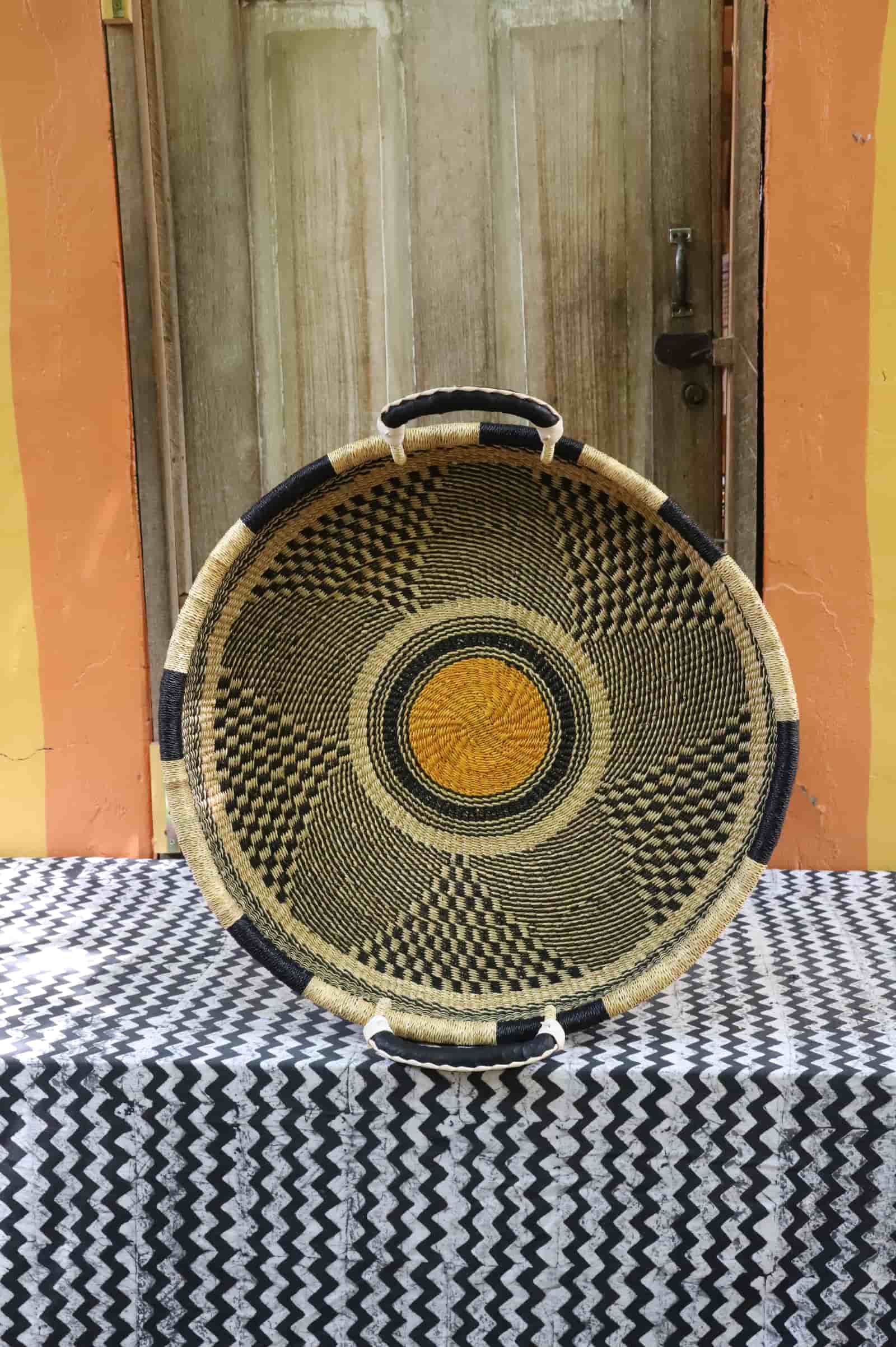 Medium double weave woven tray wall décor with a black and natural geometric checker pattern and gold centre.