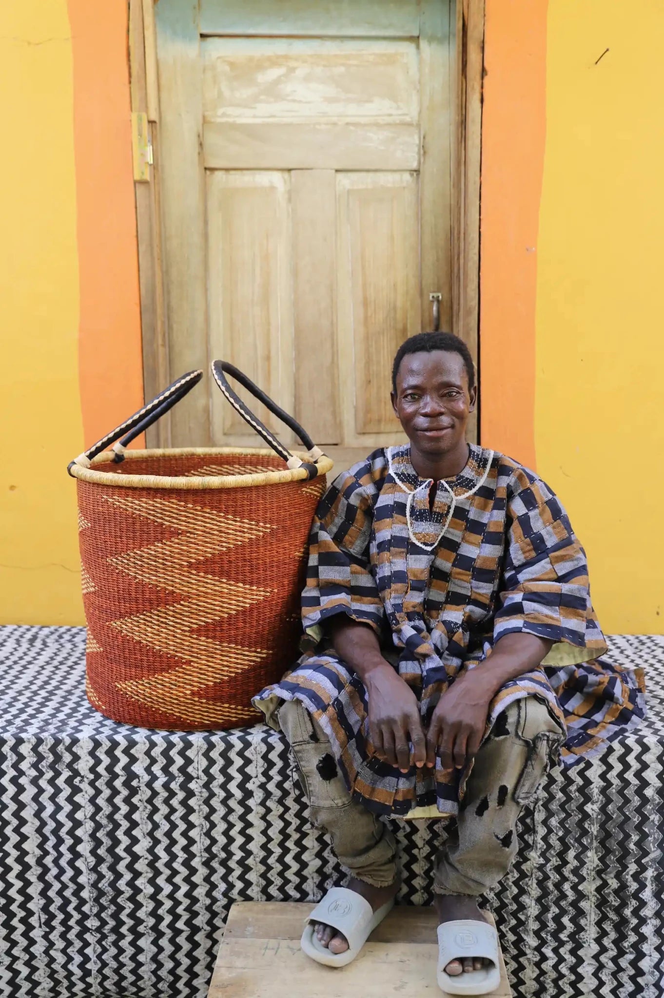 Open Laundry Basket (Large) by The Baba Tree. Handwoven elephant grass storage with leather handles. Bolgatanga artisan decor.