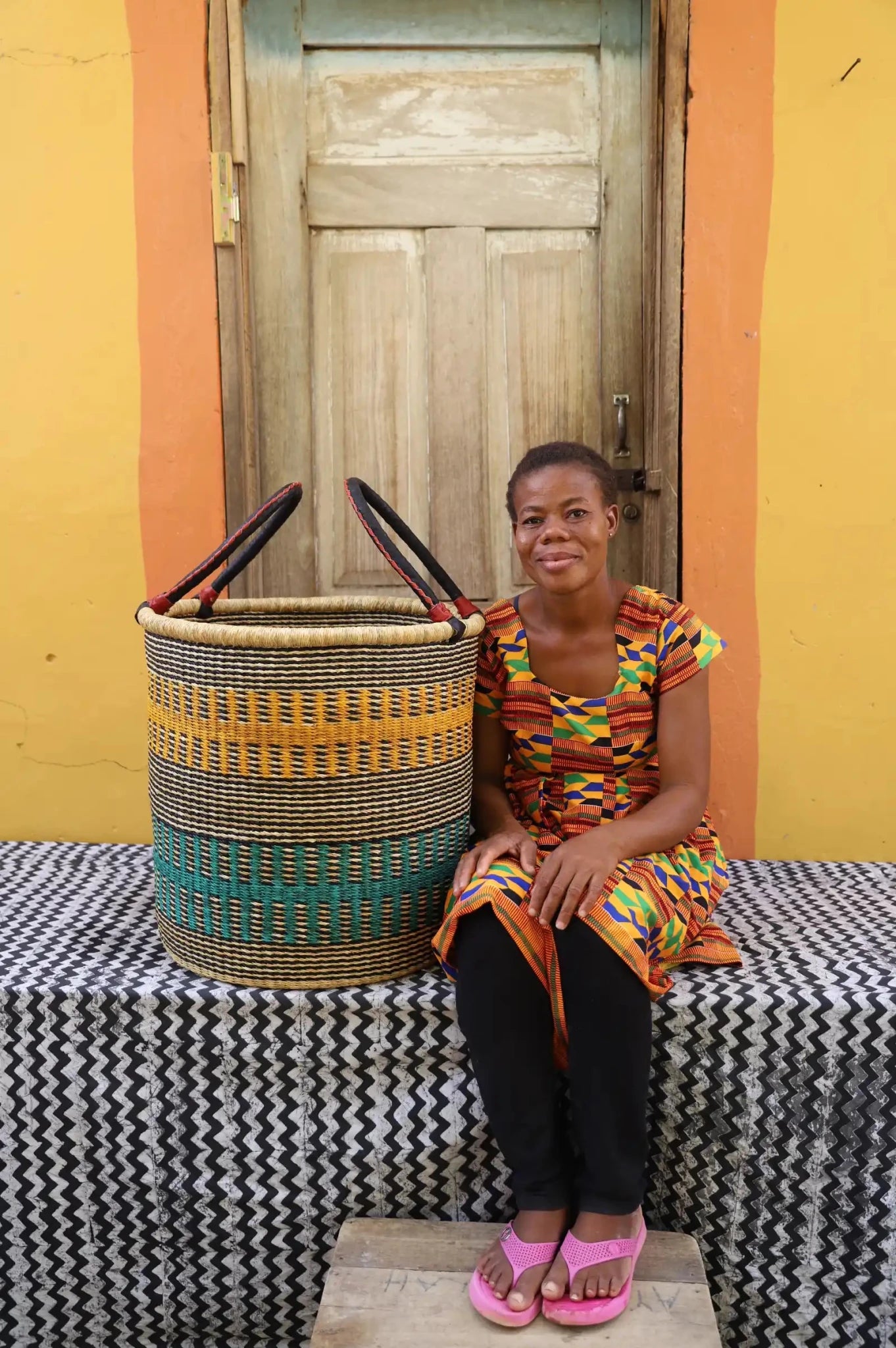 Open Laundry Basket (Large) by The Baba Tree. Handwoven elephant grass storage with leather handles. Bolgatanga artisan decor.