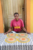 Set of 4 small placemats in yellow and black radial stripes with terracotta centres