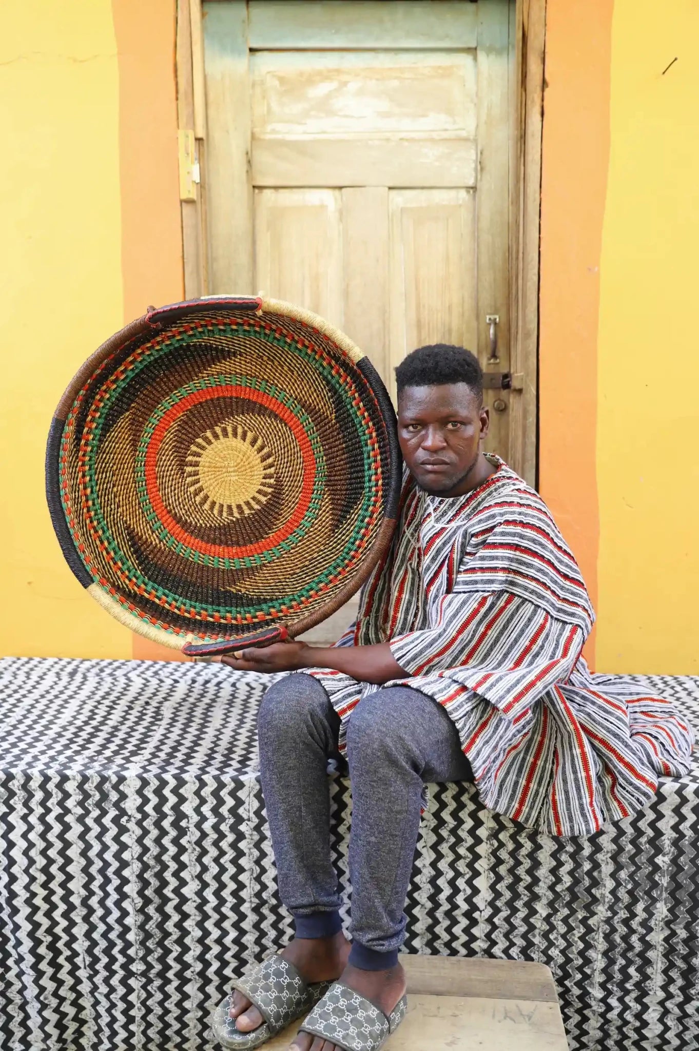 Premium elephant grass tray with leather handles. Bolgatanga artisan craftsmanship.