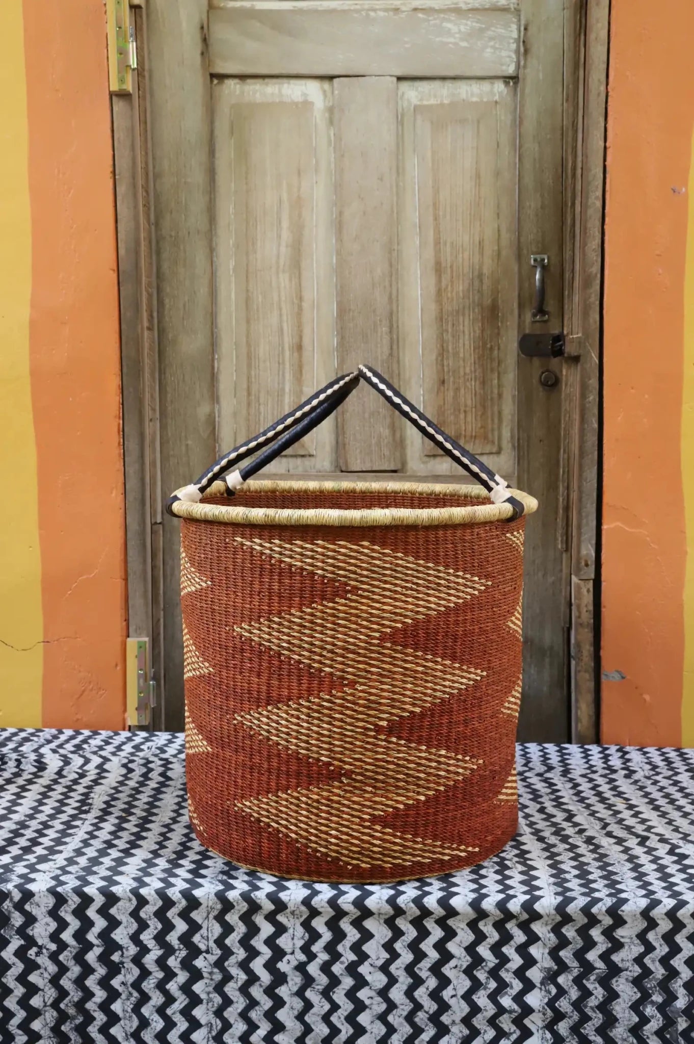 Open Laundry Basket (Large) by The Baba Tree. Handwoven elephant grass storage with leather handles. Bolgatanga artisan decor.