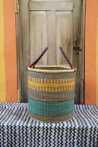 Open Laundry Basket (Large) by The Baba Tree. Handwoven elephant grass storage with leather handles. Bolgatanga artisan decor.