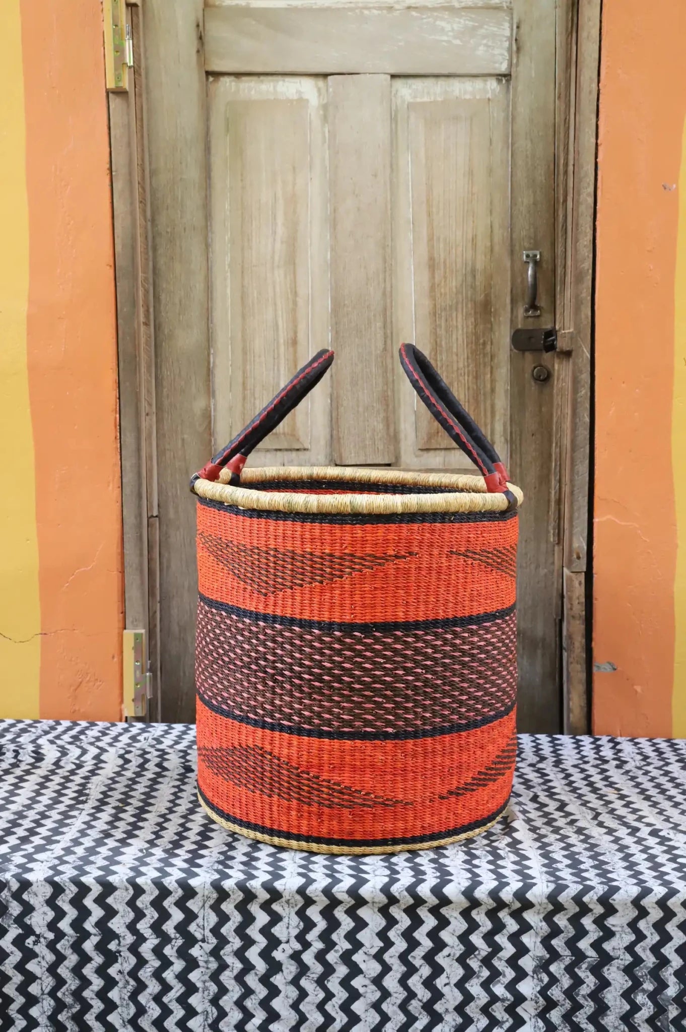 Open Laundry Basket (Large) by The Baba Tree. Handwoven elephant grass storage with leather handles. Bolgatanga artisan decor.