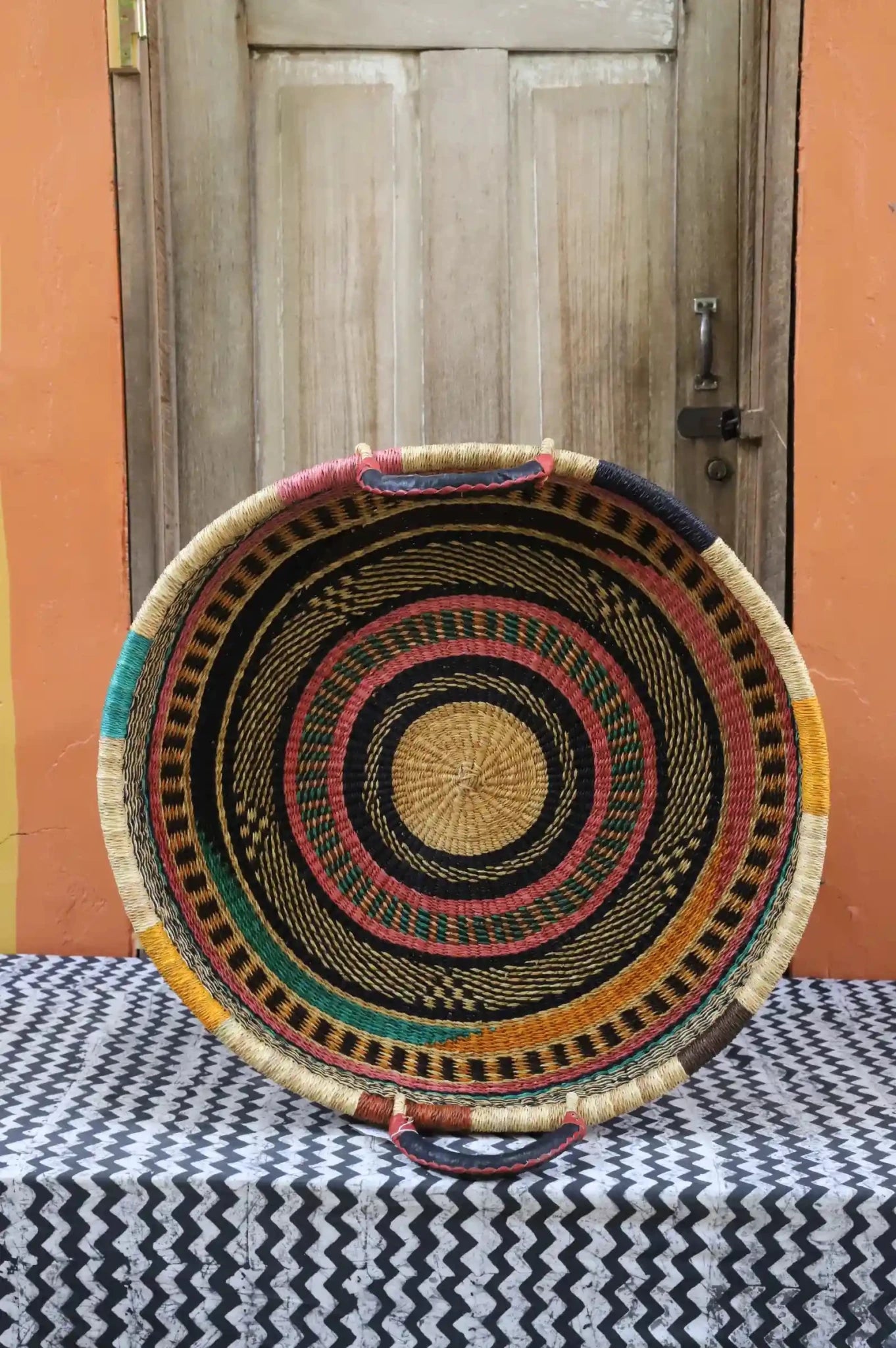 Premium elephant grass tray with leather handles. Bolgatanga artisan craftsmanship.