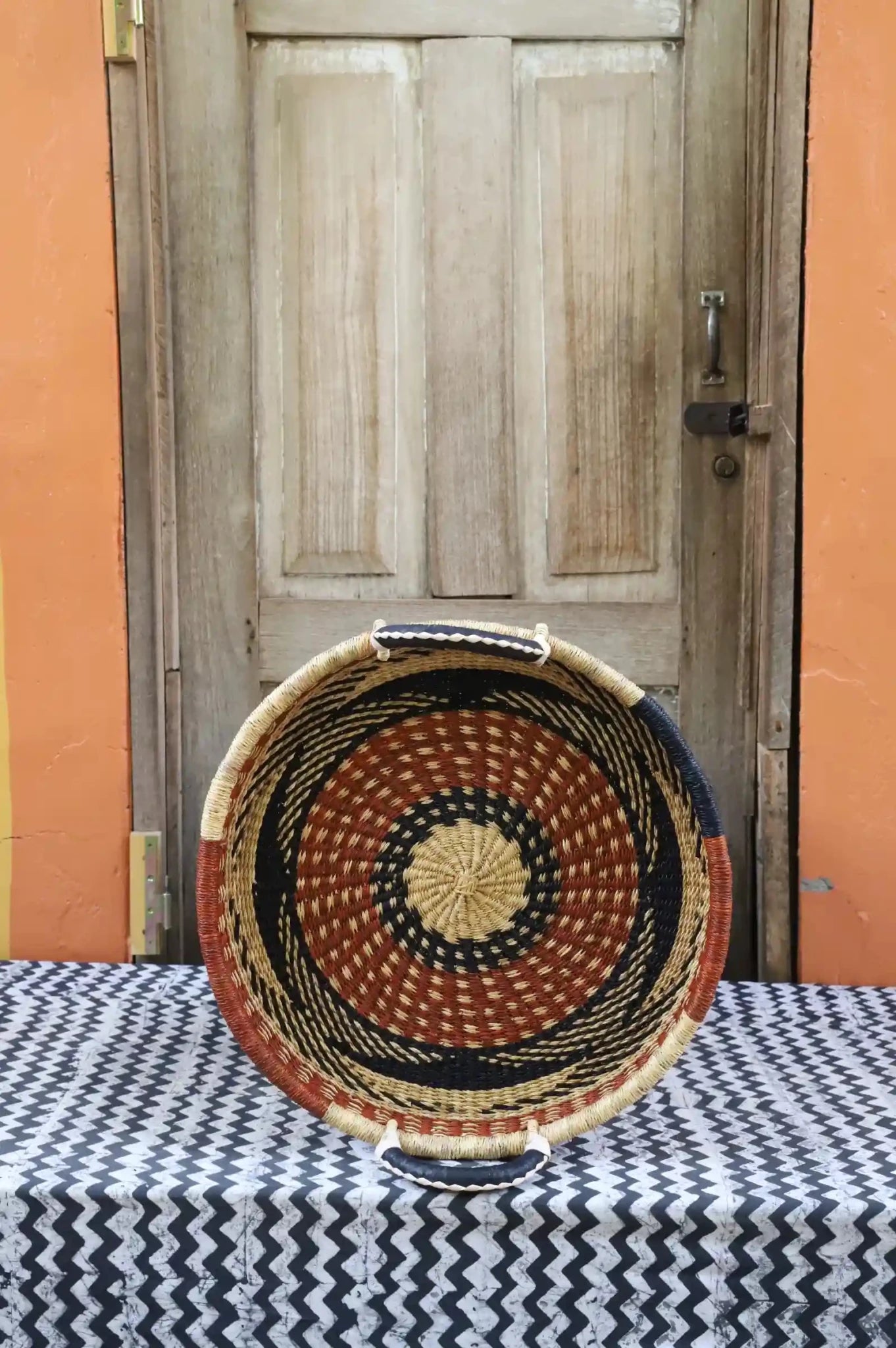 Premium elephant grass tray with leather handles. Bolgatanga artisan craftsmanship.