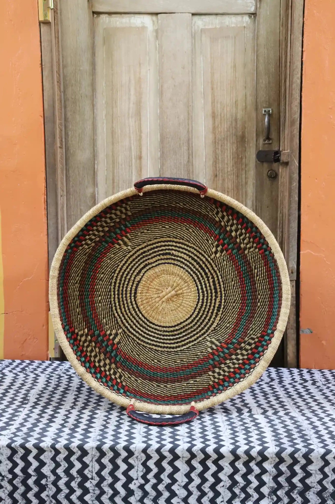 Premium elephant grass tray with leather handles. Bolgatanga artisan craftsmanship.