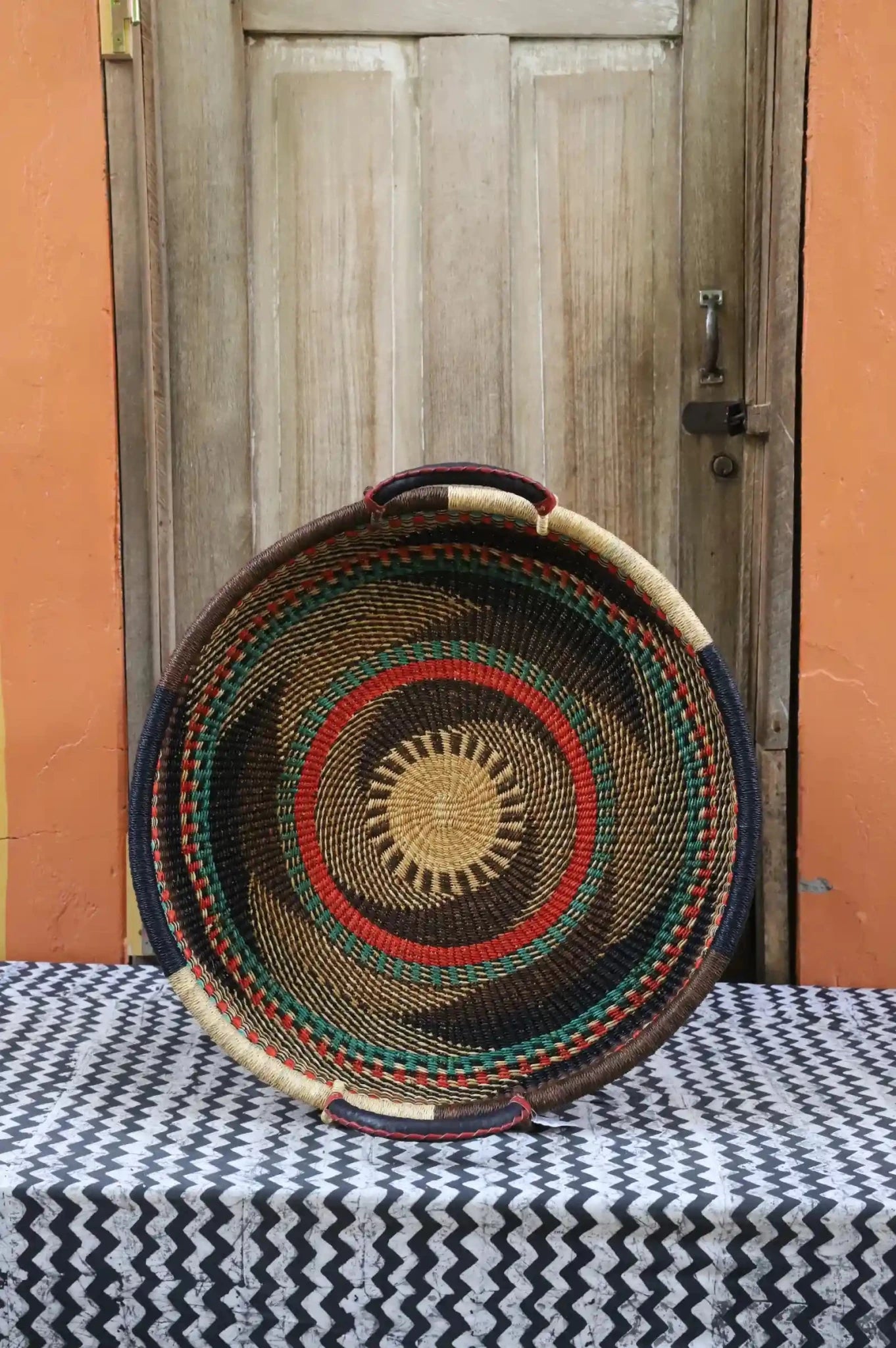 Premium elephant grass tray with leather handles. Bolgatanga artisan craftsmanship.