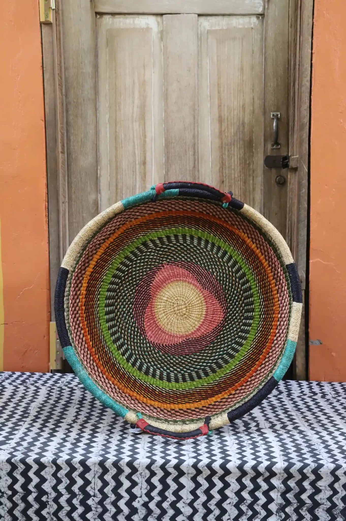 Premium elephant grass tray with leather handles. Bolgatanga artisan craftsmanship.