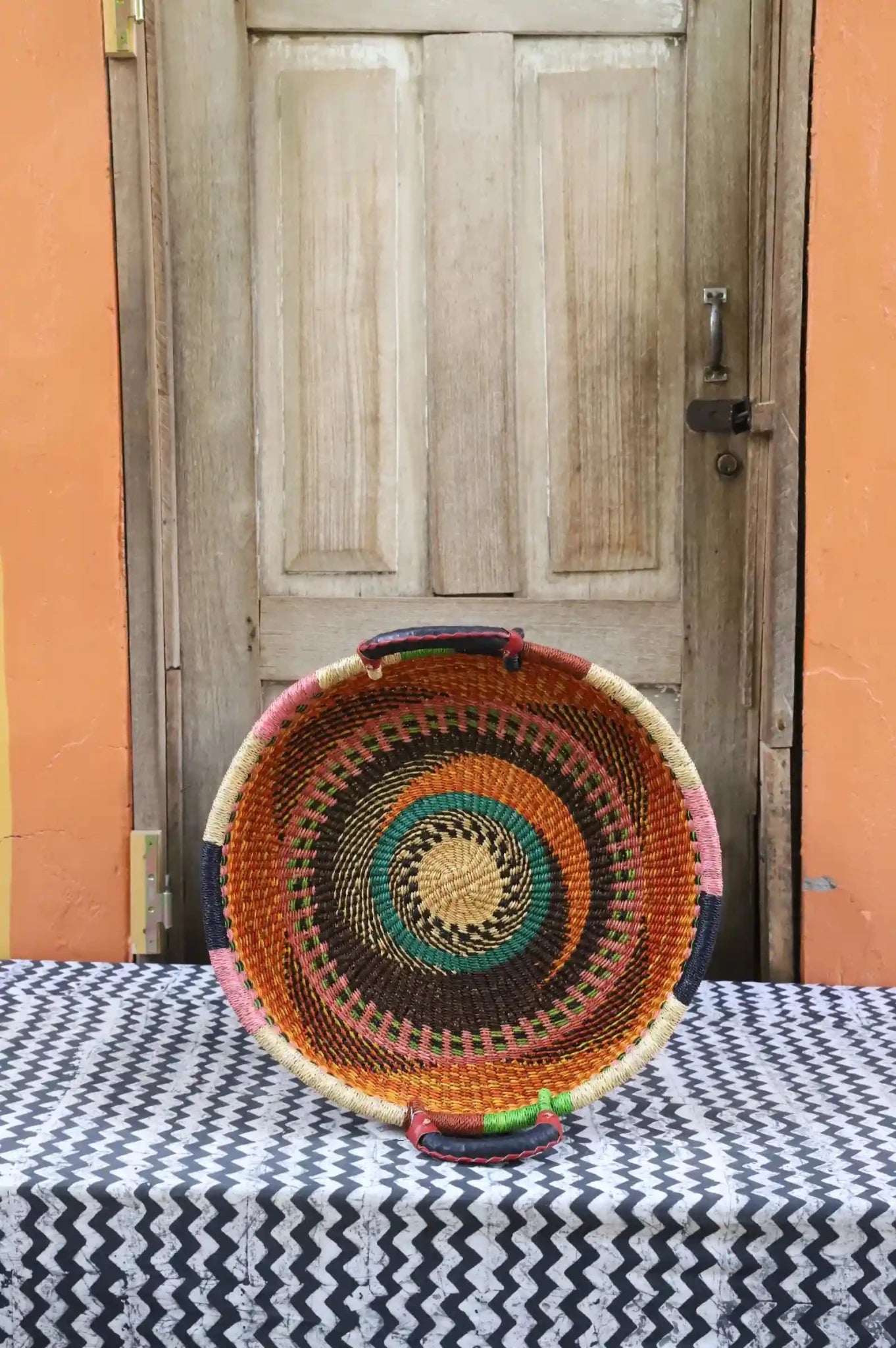 Premium elephant grass tray with leather handles. Bolgatanga artisan craftsmanship.